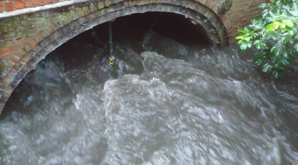 During the flood, the acrow props restricting flow with weeds and debris collected